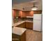 Open kitchen featuring wood cabinets, laminate countertops, dual basin sink, and a white refrigerator at 2569 W Berridge Ln # D-115, Phoenix, AZ 85017