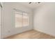 This bedroom features a ceiling fan, hardwood floors, and window with blinds at 28072 N Quartz Dr, San Tan Valley, AZ 85143
