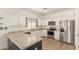 Bright kitchen features white cabinets, stainless appliances, and a spacious speckled countertop at 28072 N Quartz Dr, San Tan Valley, AZ 85143