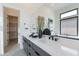 Modern bathroom featuring a double sink vanity, sleek countertops and minimalist decor with an adjacent closet at 28421 N 59Th Way, Cave Creek, AZ 85331