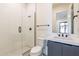 Modern bathroom featuring a glass-enclosed shower with matte black fixtures and sleek white tile at 28421 N 59Th Way, Cave Creek, AZ 85331