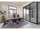 Dining area featuring a modern table, chairs, and large sliding glass doors to the backyard at 28421 N 59Th Way, Cave Creek, AZ 85331