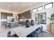 Bright dining area adjacent to kitchen featuring a modern table, chairs, and decorative mirrors at 28421 N 59Th Way, Cave Creek, AZ 85331