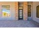 Home entrance showcasing a modern, multi-paneled door and sidelight windows at 28421 N 59Th Way, Cave Creek, AZ 85331