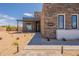 Home exterior with desert landscaping and a modern entrance featuring a sleek, multi-paneled front door at 28421 N 59Th Way, Cave Creek, AZ 85331