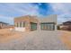 Modern home featuring a stone facade, large garage doors, and desert landscaping at 28421 N 59Th Way, Cave Creek, AZ 85331