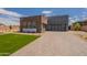 Modern home showcasing a stone facade, clean lines, and paved driveway at 28421 N 59Th Way, Cave Creek, AZ 85331