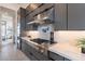 Modern kitchen featuring a stainless steel gas range, gray cabinets, and elegant countertops at 28421 N 59Th Way, Cave Creek, AZ 85331