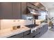 Well-lit kitchen with stainless steel appliances, granite countertops, and elegant gray cabinetry at 28421 N 59Th Way, Cave Creek, AZ 85331