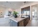 Modern kitchen with an island featuring a stainless steel sink and modern gray cabinets at 28421 N 59Th Way, Cave Creek, AZ 85331