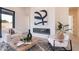Stylish living room showcasing fireplace with modern art and decor, and comfortable seating arrangements at 28421 N 59Th Way, Cave Creek, AZ 85331