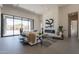 Bright living room featuring a large sliding glass door, fireplace, and stylish decor at 28421 N 59Th Way, Cave Creek, AZ 85331