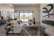 Open living space with a sleek fireplace, modern furniture, and large sliding glass doors at 28421 N 59Th Way, Cave Creek, AZ 85331