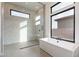 Bright main bathroom featuring a freestanding tub, marble shower, and a large window with a view for luxurious living at 28421 N 59Th Way, Cave Creek, AZ 85331