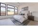 Bright main bedroom featuring black frame windows, stylish lamps, and modern art for a serene retreat at 28421 N 59Th Way, Cave Creek, AZ 85331
