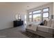 Bright main bedroom with large windows, stylish decor, and bedside table with a view to the outdoor patio at 28421 N 59Th Way, Cave Creek, AZ 85331