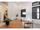 Chic office area featuring a wooden desk, patterned rug, and minimalist decor creating an inviting workspace at 28421 N 59Th Way, Cave Creek, AZ 85331