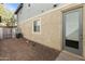 The backyard features a gray door, gravel, and a view of the home's exterior at 2947 N Evergreen St, Buckeye, AZ 85396