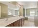 Bathroom featuring double sinks, a large mirror, and a shower and tub combo at 2947 N Evergreen St, Buckeye, AZ 85396