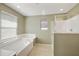 A well-lit bathroom with a large soaking tub and glass enclosed shower at 2947 N Evergreen St, Buckeye, AZ 85396