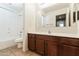 The bright bathroom features a shower-tub combo, a toilet, and a vanity with dark wood cabinets at 2947 N Evergreen St, Buckeye, AZ 85396