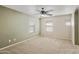 Spacious bedroom with carpet, a ceiling fan, neutral paint and window with blinds at 2947 N Evergreen St, Buckeye, AZ 85396