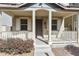 Close-up of the inviting covered front porch with classic pillars and a well-maintained garden at 2947 N Evergreen St, Buckeye, AZ 85396