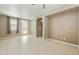 Large living room with tiled floors and a view of an archway to the kitchen area at 2947 N Evergreen St, Buckeye, AZ 85396