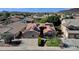 Aerial view of the home showcasing a well-manicured front yard, and a three-car garage with solar panels at 3202 W Knudsen Dr, Phoenix, AZ 85027