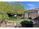 Lush backyard featuring a rock water feature, mature trees, and a pergola with seating, ideal for outdoor enjoyment at 3202 W Knudsen Dr, Phoenix, AZ 85027