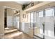 Clean, well-lit bathroom with a shower, glass doors, a bathtub, and a full-length mirror at 3202 W Knudsen Dr, Phoenix, AZ 85027