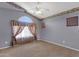 Cozy bedroom with arched window, neutral carpet, and light blue walls with complementary trim at 3202 W Knudsen Dr, Phoenix, AZ 85027