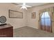 Inviting bedroom with neutral walls, carpet, and a window, well-lit by a modern ceiling fan at 3202 W Knudsen Dr, Phoenix, AZ 85027