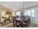 Open-concept dining room with a chandelier and large windows offering lots of light at 3202 W Knudsen Dr, Phoenix, AZ 85027