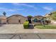 Inviting home with a well-maintained front lawn, mature tree, and a three-car garage at 3202 W Knudsen Dr, Phoenix, AZ 85027
