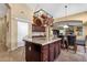 Open kitchen featuring a central island, granite counters, and tile flooring at 3202 W Knudsen Dr, Phoenix, AZ 85027