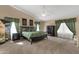 Relaxing primary bedroom with a ceiling fan, carpet flooring, and custom curtains offers a serene retreat at 3202 W Knudsen Dr, Phoenix, AZ 85027