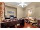 Well-lit office features a large wooden desk, comfortable chair, and tasteful decor with a ceiling fan at 3202 W Knudsen Dr, Phoenix, AZ 85027