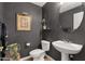 Tastefully decorated powder room with dark wallpaper, a round mirror, and a pedestal sink is ideal for guests at 3202 W Knudsen Dr, Phoenix, AZ 85027