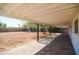 Backyard patio with brick floors and view of the dirt backyard and the fence in the distance at 3249 E Sunnyside Ln, Phoenix, AZ 85032