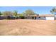 Exterior shot from the backyard shows a large dirt yard and the back of the home at 3249 E Sunnyside Ln, Phoenix, AZ 85032