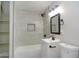 Bright bathroom featuring tiled shower with niche, modern vanity, and updated fixtures at 3249 E Sunnyside Ln, Phoenix, AZ 85032
