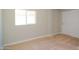 Neutral bedroom features tan carpet, light paint, one window, and closet at 3249 E Sunnyside Ln, Phoenix, AZ 85032