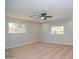 Large bedroom featuring tan carpet, two windows, ceiling fan, and recessed lighting at 3249 E Sunnyside Ln, Phoenix, AZ 85032