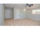 Large bedroom featuring tan carpet, one window, ceiling fan, and two doors at 3249 E Sunnyside Ln, Phoenix, AZ 85032