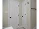 Hallway featuring two white painted doors, neutral wall color, and matte black hardware at 3249 E Sunnyside Ln, Phoenix, AZ 85032