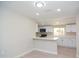 Bright kitchen area showcasing white cabinets, quartz countertops, and breakfast bar seating at 3249 E Sunnyside Ln, Phoenix, AZ 85032
