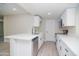 Well-lit kitchen featuring white cabinets, a stainless steel dishwasher, and quartz countertops at 3249 E Sunnyside Ln, Phoenix, AZ 85032