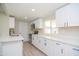 Beautiful bright kitchen with white cabinets, stainless steel appliances and quartz countertops at 3249 E Sunnyside Ln, Phoenix, AZ 85032