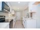 Well-equipped kitchen featuring stainless steel appliances, white cabinets, and quartz countertops at 3249 E Sunnyside Ln, Phoenix, AZ 85032